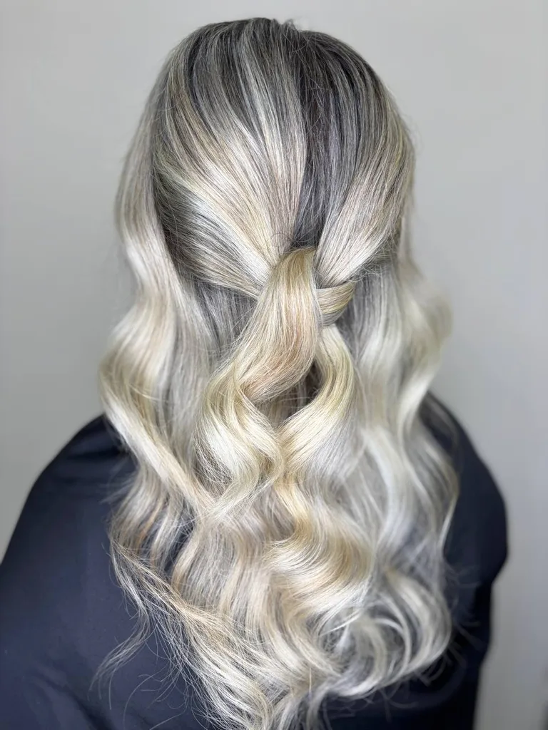 Păr lung cu rădăcină închisă și lungimi blond platinat, prins parțial, cu bucle