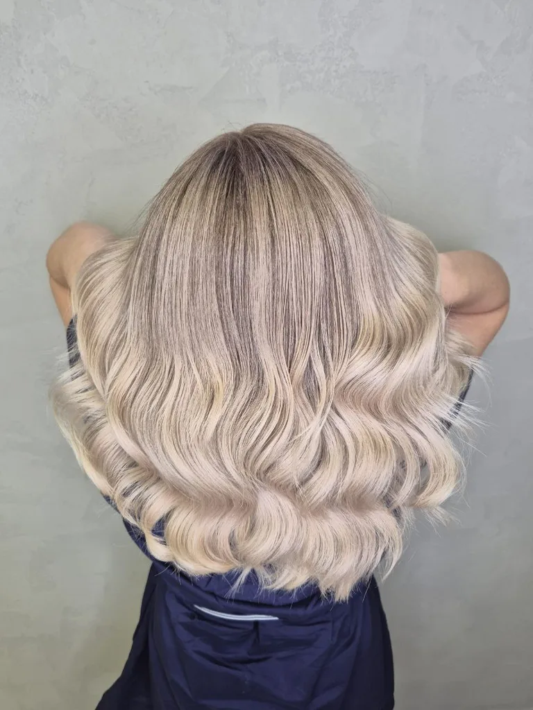 Păr lung blond perlat cu rădăcină umbrită, ondulat